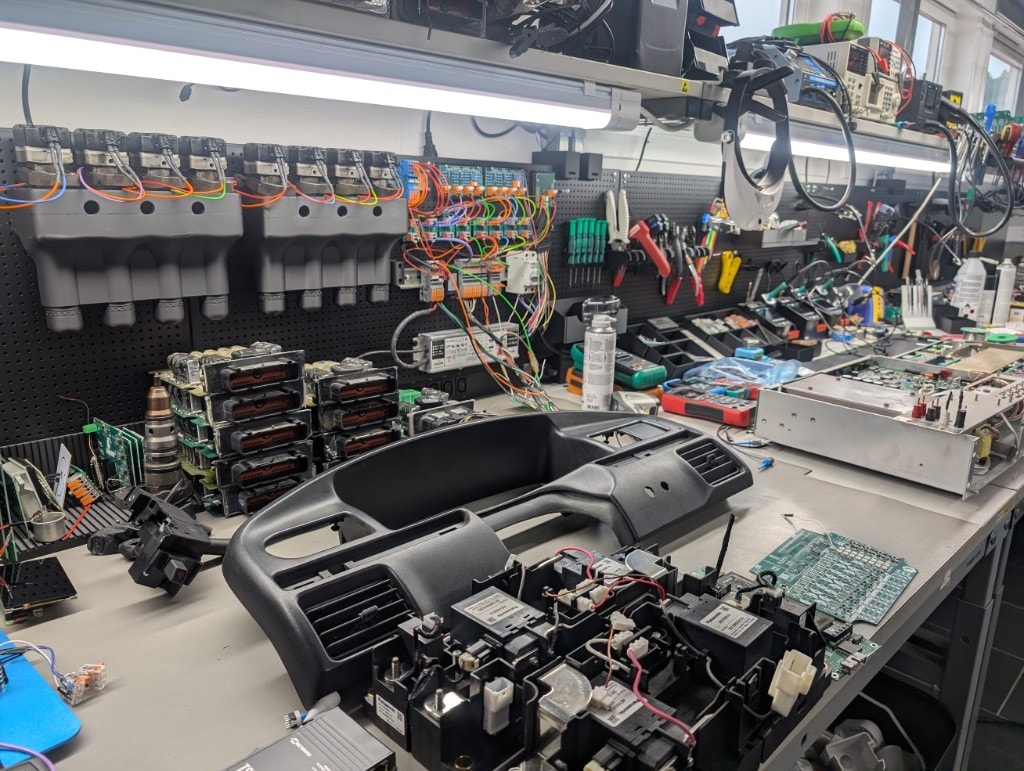 Electronics assembly and rework bench with vehicle modules and test equipment